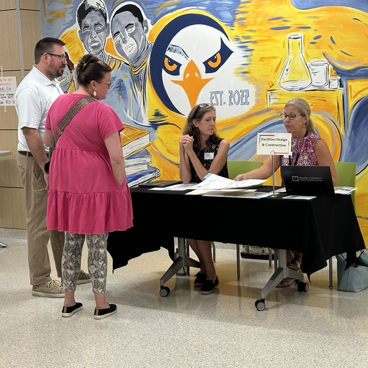  Parents talking to district staff at the enrollment open house